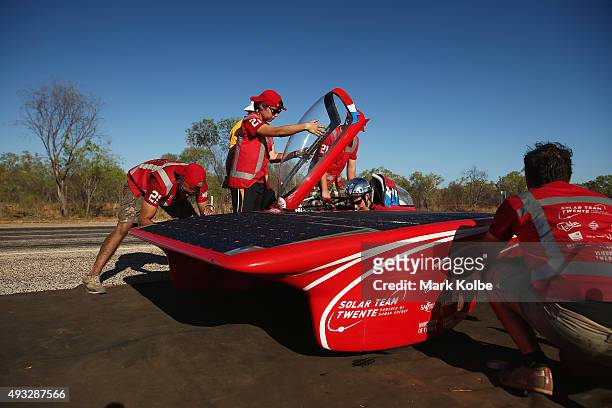 Team members prepare their car Red One of Solar Team Twente Netherlands before racing in the Challenger Class between Dunmarra and Elliott during day...