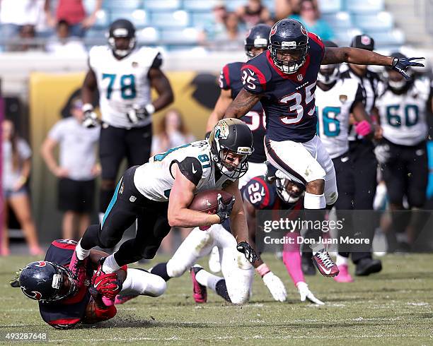 Wide Receiver Bryan Walters of the Jacksonville Jaguars is shoestring tackled by Safety Rahim Moore of the Houston Texans during the game at EverBank...