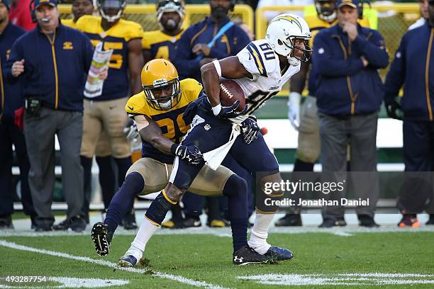 Malcom Floyd of the San Diego Chargers is tackled by Casey Hayward of the Green Bay Packers after making a catch for a first down in the second...