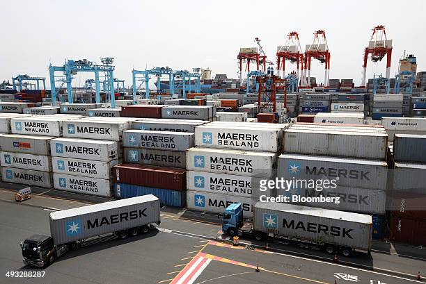 Trucks carry Maersk containers at the container yard operated by A.P. Moeller-Maersk A/S in Yokohama, Japan, on Friday, May 23, 2014. A.P....
