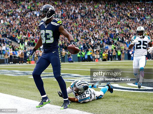 Ricardo Lockette of the Seattle Seahawks celebrates a touchdown catch over Kurt Coleman of the Carolina Panthers at CenturyLink Field on October 18,...