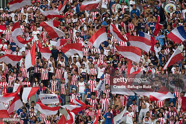 Fans of Chivas cheer for their team during the 13th round match between Chivas and Puebla as part of the Apertura 2015 Liga MX at Omnilife Stadium on...