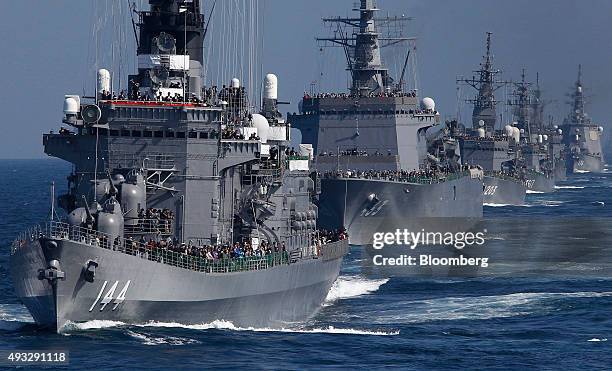 Japan's Maritime Self-Defense Force destroyer ship Kurama, left, leads a troop of vessels during a fleet review at Sagami Bay, off Yokosuka, Kanagawa...