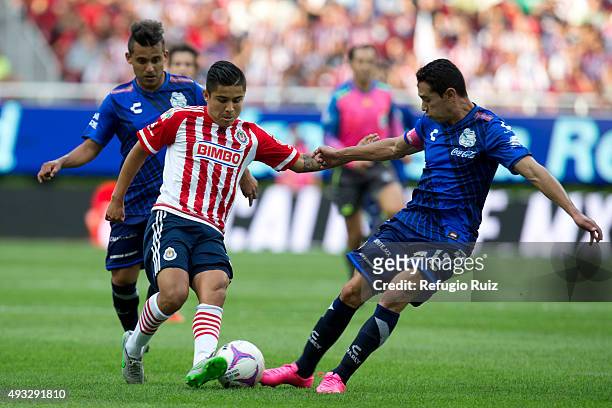 Angel Saldivar of Chivas, fights for the ball with Oscar Rojas of Puebla during the 13th round match between Chivas and Puebla as part of the...