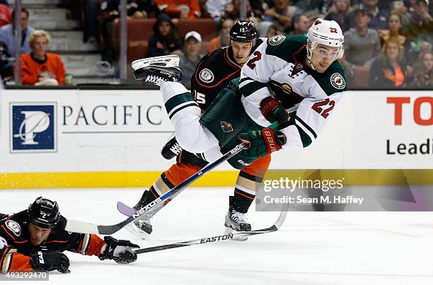 Nino Niederreiter of the Minnesota Wild leaves his skates as Kevin Bieksa of the Anaheim Ducks and Ryan Getzlaf of the Anaheim Ducks defend during...