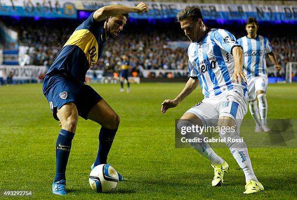 Jonathan Calleri of Boca Juniors fights for the ball with Ivan Pillud of Racing Club during a match between Racing Club and Boca Juniors as part of...