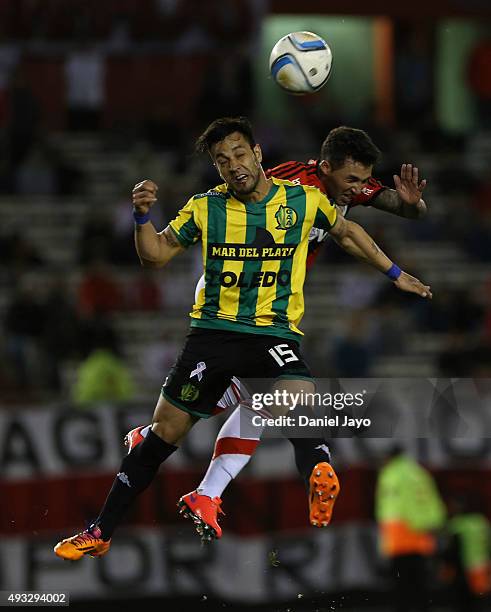 Angel Diaz, of Aldosivi, and Tabare Viudez, of River Plate, go for a header during a match between River Plate and Aldosivi as part of round 28 of...