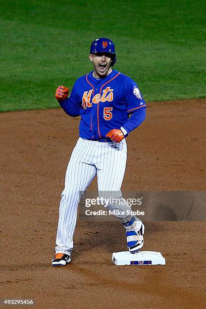 David Wright of the New York Mets celebrates his RBI double to score Curtis Granderson in the first inning against Jake Arrieta of the Chicago Cubs...