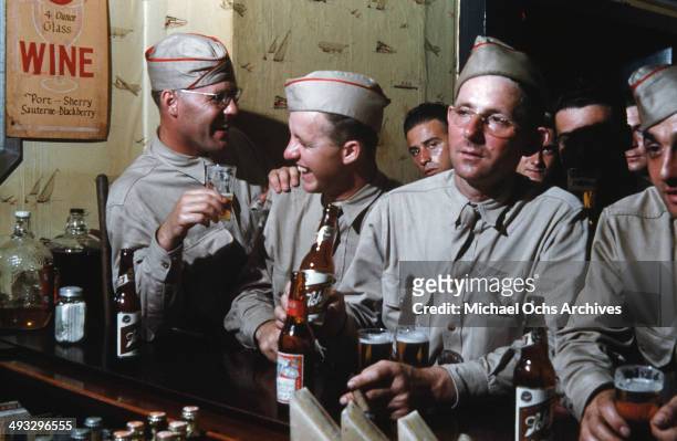 View of army soldiers off duty drink beer at a local bar in Fayetteville, North Carolina in 1942.
