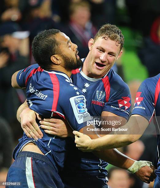 Telusa Veainu of the Rebels is congratulated by Scott Higginbotham after scoring a try during the round 15 Super Rugby match between the Rebels and...