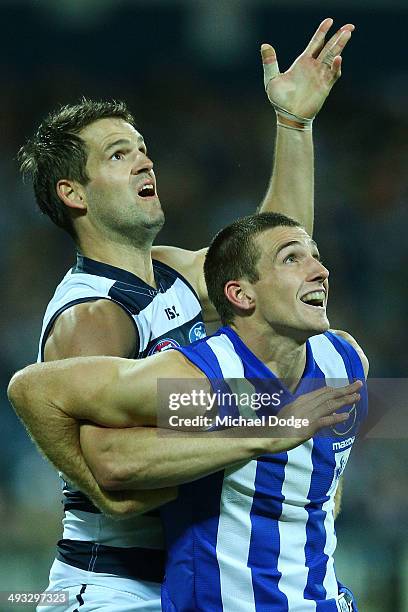 Jared Rivers of the Cats competes for the ball against Shaun Atley of the Kangaroos during the round 10 AFL match between the Geelong Cats and the...