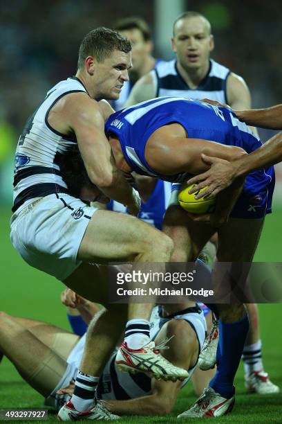 Joel Selwood of the Cats tackles Michael Firrito of the Kangaroos during the round 10 AFL match between the Geelong Cats and the North Melbourne...