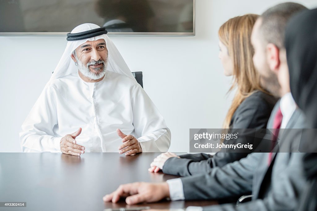 Mature Middle Eastern businessman wearing ghoutra in meeting