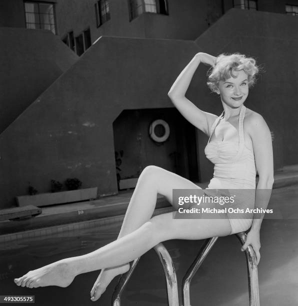 Circa 1953: Actress Anne Francis poses in a swimming pool in Los Angeles, California.