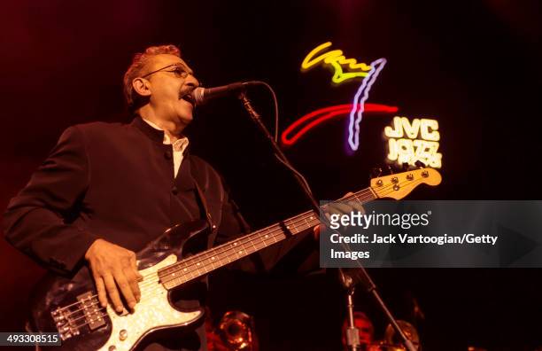 Cuban musician Juan Formell plays upright electric bass as he leads the dance band Los Van Van during a JVC Jazz Festival concert at Hammerstein...