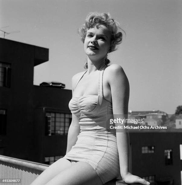 Circa 1953: Actress Anne Francis poses by the swimming pool in Los Angeles, California.