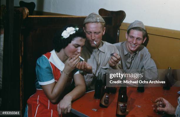 View of army soldiers off duty drink beer at a local bar and meet girls in Fayetteville, North Carolina in 1942.