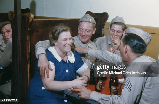 View of army soldiers off duty drink beers at a local bar and meet girls in Fayetteville, North Carolina in 1942.