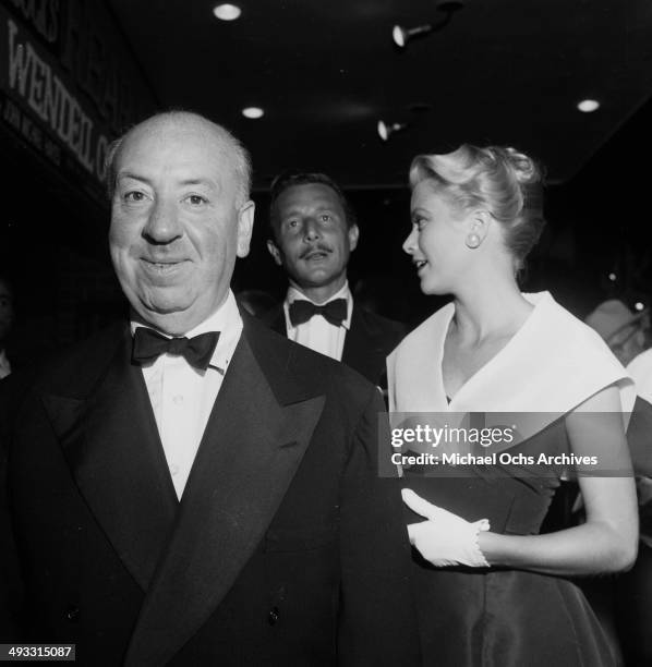 Director Alfred Hitchcock with actress Grace Kelly and Oleg Cassini at the premier of "Rear Window" in Los Angeles, California.