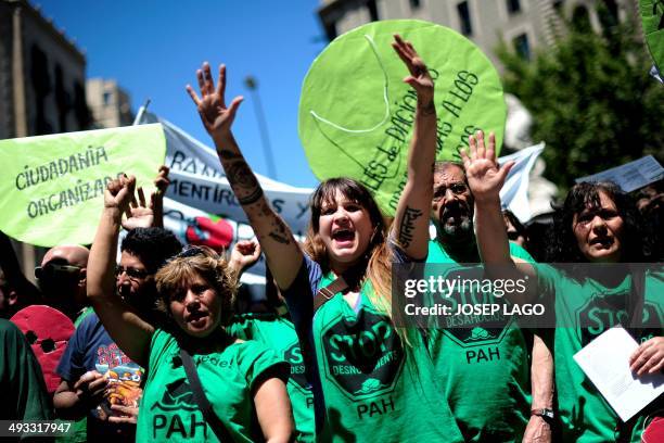 Anti-eviction activists of the PAH shout during a protest held outside a hotel during a meeting attended by Popular Party leader of the Catalonia...