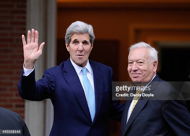 Secretary of State John Kerry waves with Spanish Foreign Minister Jose Manuel Garcia-Margallo before meeting with Spanish Prime Minister Mariano...