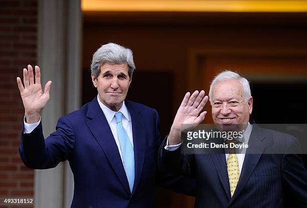 Secretary of State John Kerry waves with Spanish Foreign Minister Jose Manuel Garcia-Margallo before meeting with Spanish Prime Minister Mariano...