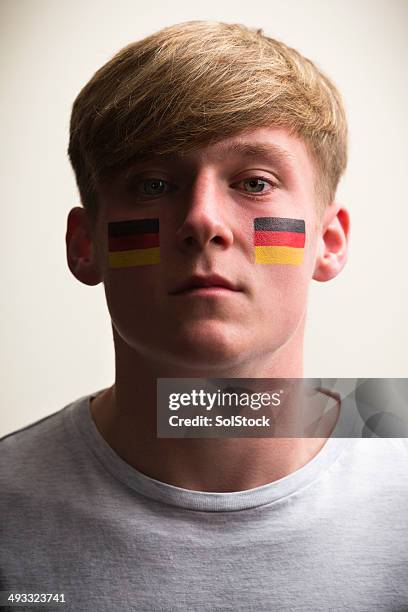 male sports fan with flag painted on face - faces of a nation stock pictures, royalty-free photos & images