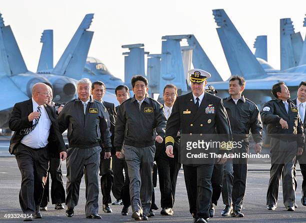 Japanese Prime Minister Shinzo Abe inspects the U.S. Navy nuclear aircarrier USS Ronald Ragan during the Japan Maritime Self-Defense Force fleet...