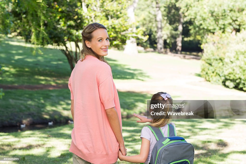 Mother with schoolgirl in park