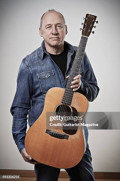 Portrait of British musician and composer Mark Knopfler photographed with vintage 1930's Martin D-18 acoustic guitar at his studio in London, on...