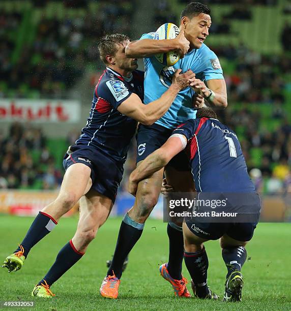 Israel Folau of the Waratahs is tackled by Jason Woodward of the Rebels during the round 15 Super Rugby match between the Rebels and the Waratahs at...