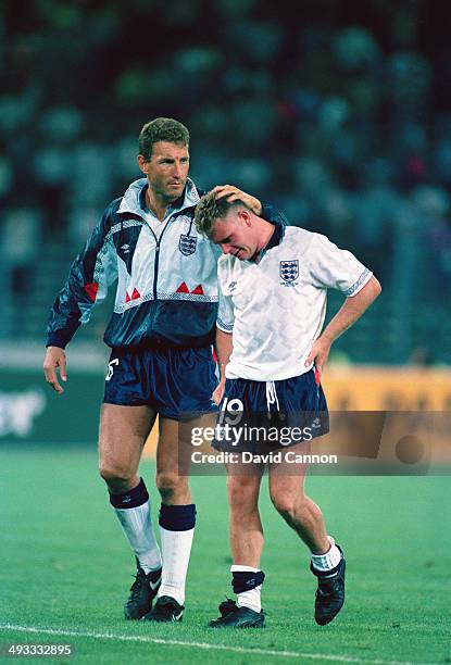 Tearful Paul Gascoigne is consoled by team mate Terry Butcher after loosing the FIFA World Cup Finals 1990 Semi- Final match between West Germany and...