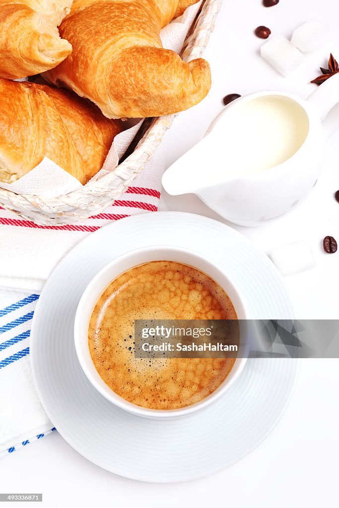 Cup of coffee with croissants