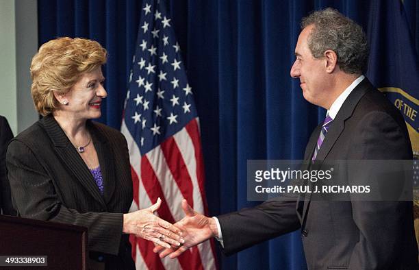 Sen. Debbie Stabenow shakes hands with US Trade Representative Ambassador Michael Froman at a press conference announcing a ruling in the favor of...
