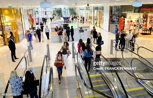 People walk in the new "Les Terrasses du Port" shopping centre in Marseille, southern France, on May 23 on the eve of its opening to the public. "Les...