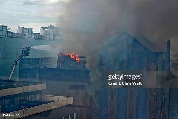 Firefighter works to put out a fire at the Glasgow School of Art Charles Rennie Mackintosh Building on May 23, 2014 in Glasgow, Scotland. The fire at...