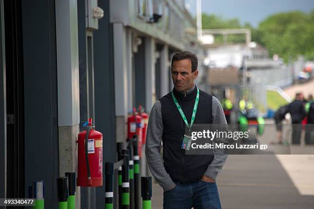 Alberto Puig of Spain walks in pit during the FIM Superbike World Championship - Free Practice at Donington Park on May 23, 2014 in Castle Donington,...