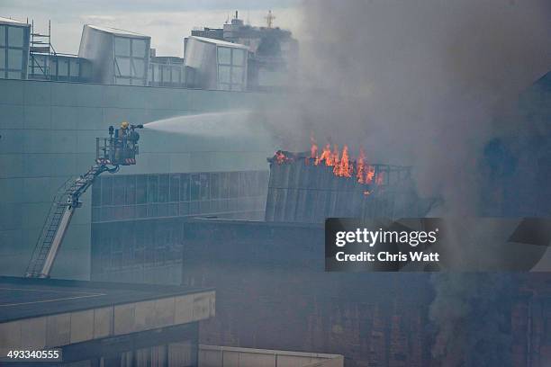 Firefighter tackles a blaze at the Glasgow School of Art Charles Rennie Mackintosh Building on May 23, 2014 in Glasgow, Scotland. The fire at the...