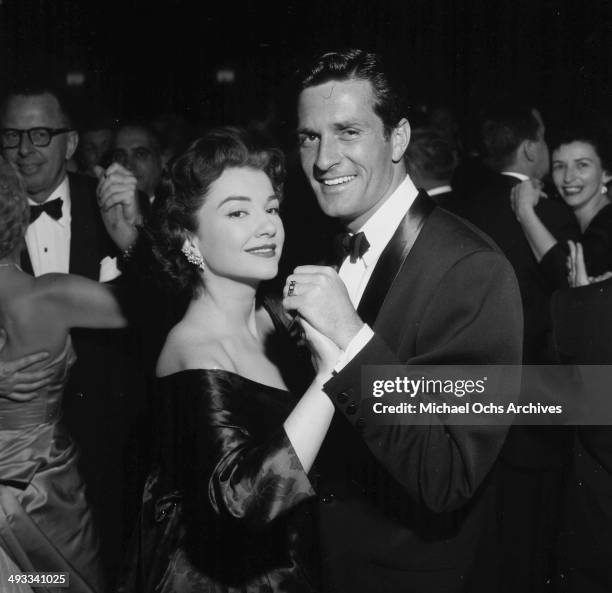 Actress Anne Baxter dances with actor Hugh O'Brian during the Screen Actors Guild party in Los Angeles, California.