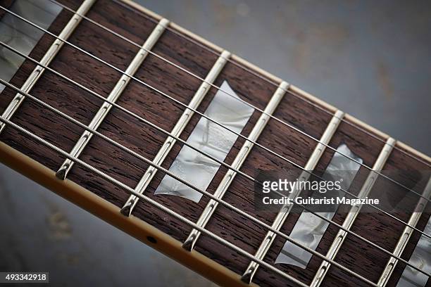 Detail of the rosewood fingerboard with trapezoid inlays on a Fano Alt de Facto ML6 electric guitar, taken on February 25, 2015.