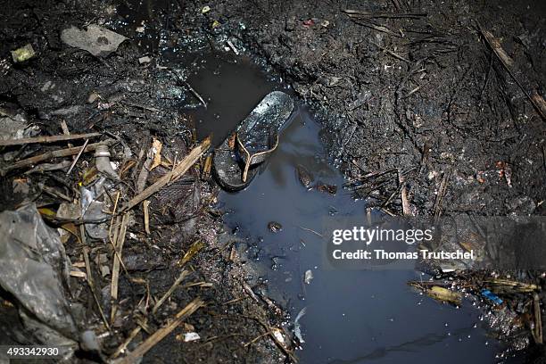 Beira, Mozambique A shoe lies in a drainage ditch in a slum in the city of Beira on September 28, 2015 in Beira, Mozambique.