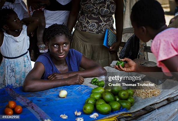 Beira, Mozambique A woman buys vegetables at a vegetable stall in a slum in the city of Beira on September 28, 2015 in Beira, Mozambique.