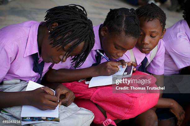 Beira, Mozambique Students wearing school uniforms write in their exercise books on September 29, 2015 in Beira, Mozambique.