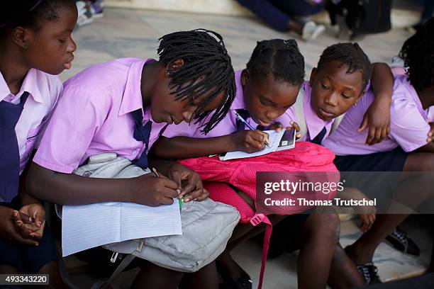 Beira, Mozambique Students wearing school uniforms write in their exercise books on September 29, 2015 in Beira, Mozambique.