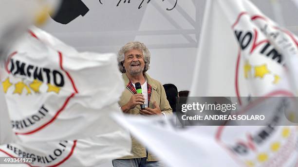 Italian anti-establishment 5-Star Movement party leader, Beppe Grillo, gives a speech as supporters wave flags on May 23, 2014 in Rome's Piazza San...