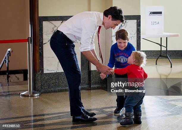 Justin Trudeau, leader of the Liberal Party of Canada, plays with his children after casting his ballot on election day in Montreal, Quebec, Canada,...