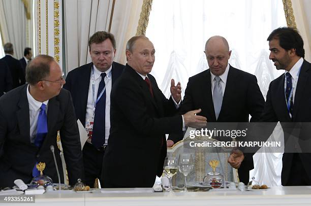 Participants of the St. Petersburg International Economic Forum 2014 led by Russian President Vladimir Putin , attend a reception, part of SPIEF...