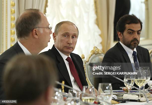 Participants of the St. Petersburg International Economic Forum 2014 led by Russian President Vladimir Putin , attend a reception, part of SPIEF...