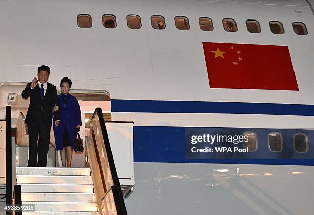 Chinese President Xi Jinping and his wife Peng Liyuan arrive for a four-day state visit at Heathrow Airport on October 19, 2015 in London, England....