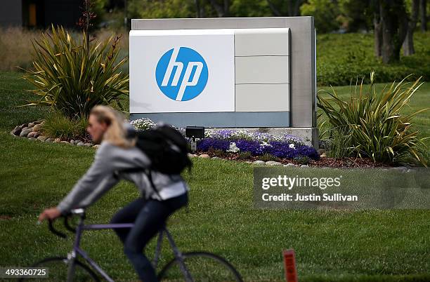 Cyclist rides by a sign outside of the Hewlett-Packard headquarters on May 23, 2014 in Palo Alto, California. HP announced on Thursday that it plans...